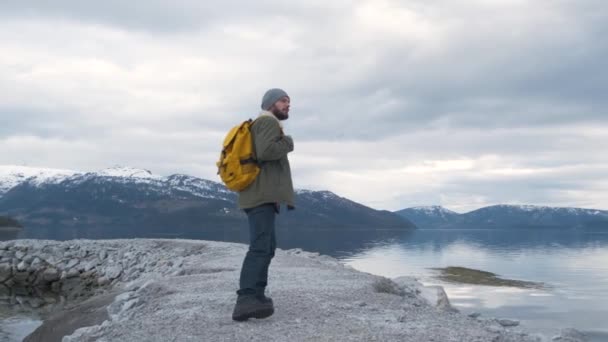 Hipster caminha pelo rio na Noruega. Hora da noite — Vídeo de Stock
