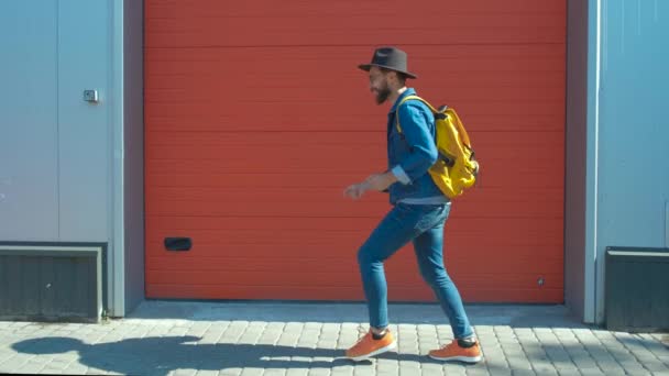 Feliz hipster emocionado de pie y celebrando el éxito sobre un fondo rojo . — Vídeo de stock