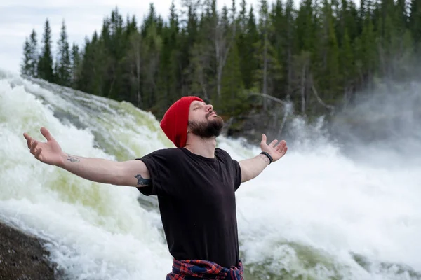 Nuori mies vaellus ulkona Lifestyle Travel selviytymisen käsite joki ja kivinen vuoret taustalla tekijänoikeusvapaita kuvapankkikuvia
