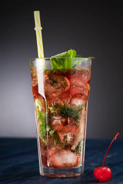 Tasty drink with ice.  Red  ice cold refreshing cocktail with mint.