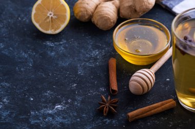 Doğal sıcak içecekle savaşmak için gerekli malzemeler. Limon, zencefil ve bal ahşap arka planda. Metin için boşluk
