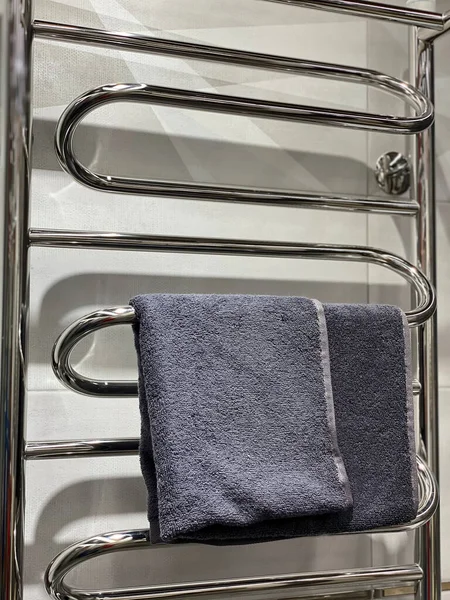 Grey towel on towel dryer.