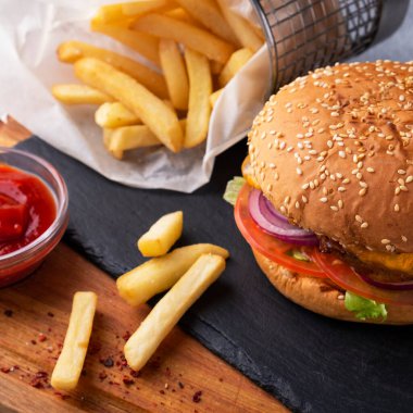 Patates kızartması ve ketçaplı ev yapımı burger. Yakın plan fotoğraf..