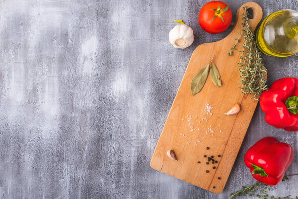 Wooden cutting board with ingredients for cooking and spices. Copy space. Top view