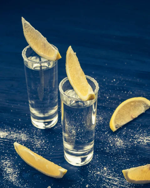 Tequila.  Alcohol in shot glasses, lemon and salt. Closeup. Toned photo