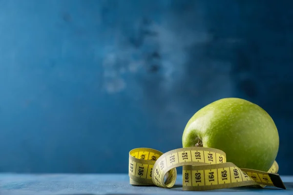 Diet life loss weight concept. Green apple and measure tap with copy space. Lifestyle