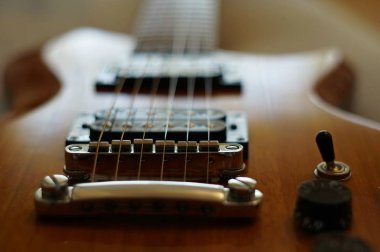 Streams and Bridges. Closeup shot of Washburn Idol WI-64 electric guitar with Tune-o-matic bridge clipart