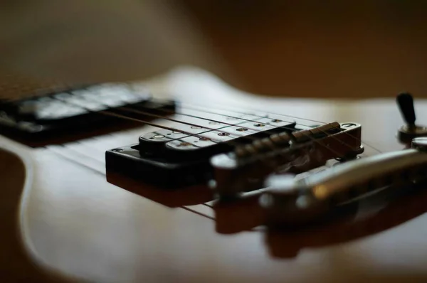 Streams and Bridges. Closeup shot of Washburn Idol WI-64 electric guitar with Tune-o-matic bridge