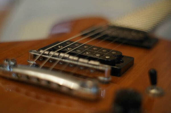 Streams and Bridges. Closeup shot of Washburn Idol WI-64 electric guitar with Tune-o-matic bridge.