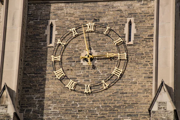 Golden clock on the wall of old gothic tower — Stock Photo, Image