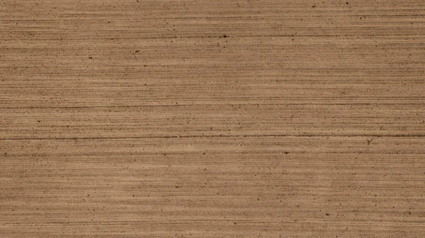 Toned background texture of concrete with textured brushed finish. Beige brush concrete texture. Sepia cement slab texture