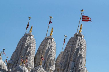 TORONTO, CANADA - 06 2016: BAPS Shri Swaminarayan mandir 'in bayraklı kubbeleri ve kuleleri BAPS Swaminarayan tarafından inşa edilmiş geleneksel bir Hindu ibadethanesidir.