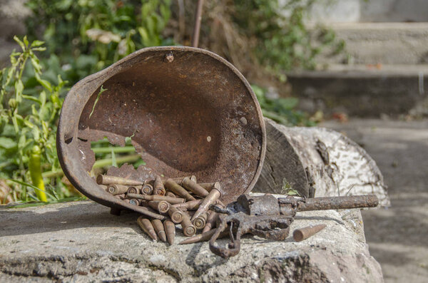 First World War memorabilia - Rusted helmet and bullets 