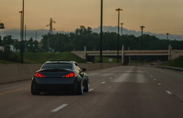 Black Customized Lowered Import Sports Car Driving Empty Highway Dusk — Stock Photo, Image