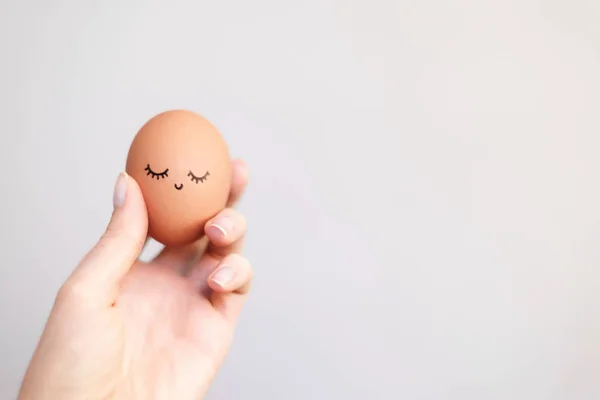 Woman holding egg with happy, funny and beautiful  face.