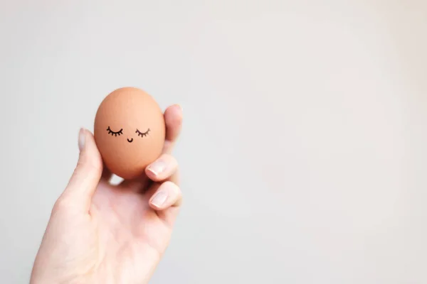 Woman holding egg with happy, funny and beautiful  face.