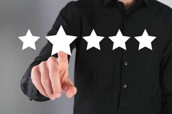 Giving a feedback, five star rate. Businessman leaves a review.