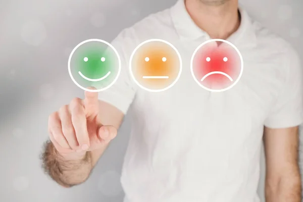 Man giving rating, leaving review with a happy face emotion icon. Product quality survey. Feedback concept.