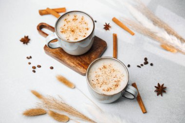 İki fincan tarçınlı kahve ve kurutulmuş otlu bir masada anason.