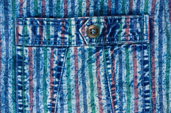 Blue washed faded jeans striped texture with seams, clasps, buttons and rivets, clothing items, macro, close-up