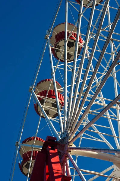 Attractions in spring city Park - Ferris Wheel Over Blue Sky