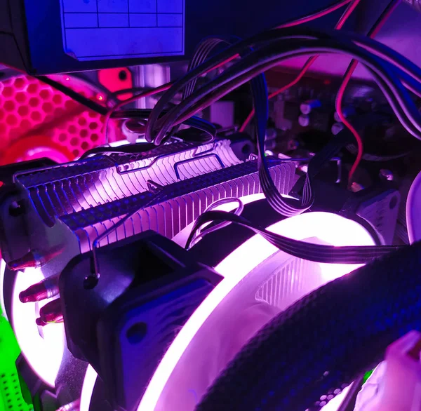 Modern computer air cooling with multi-colored led backlight-fans, cooling radiators, cables, boards, close-up.