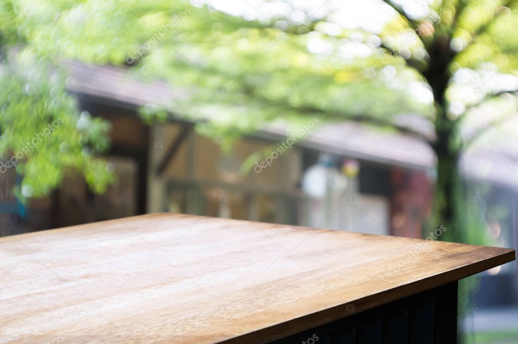 empty wooden table with blur restaurant background.