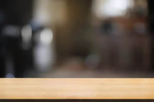 empty wood table with blur montage restaurant background.