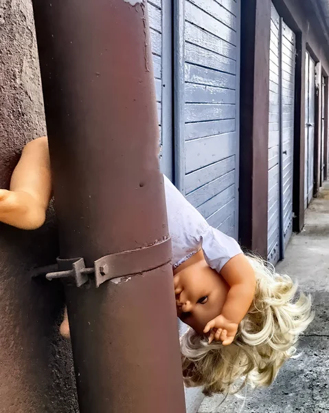 Doll upside down as a symbol of child abuse — Stock Photo, Image