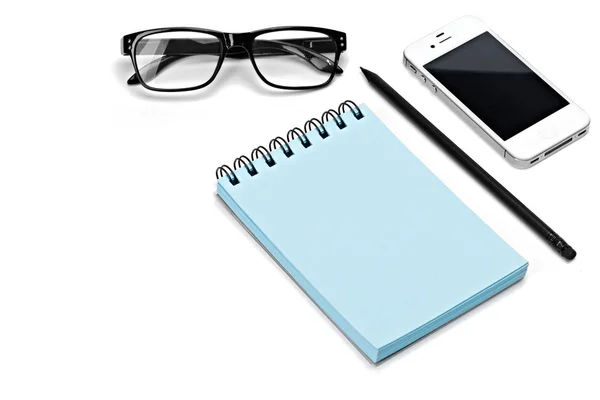 Blank template spiral blue notebook notepad, glasses, pencil, smartphone isolated white background — Stock Photo, Image