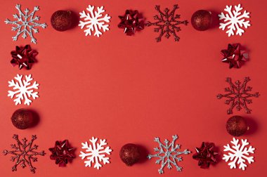 Christmas kırmızı arka plan üstten görünüm. Tatil yeni yıl topları, Noel dekoratif kar taneleri ile çerçeve tasarımı için 