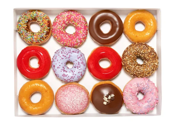 Beyaz arka planda izole pasta teslimat için karton kutuda farklı dolgular üst görünümü ile çeşitli Donuts. Tatlı Fast-Food konsepti. Kahvaltı fırın lezzetli tatlı çörek kek