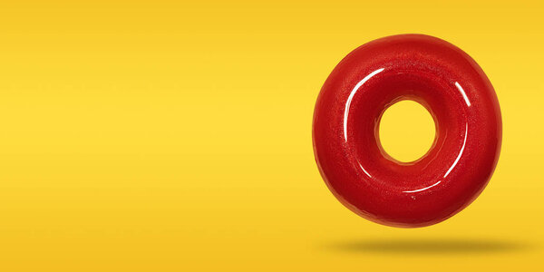 Donut with glossy red glazed in flying on pastel orange and yellow background. Front view. Copy space