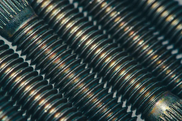 Background from automotive bolts in blue and yellow tones close up.