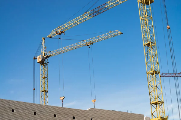 Grandi Gru Torre Sopra Edifici Costruzione Contro Cielo Blu Immagine — Foto Stock