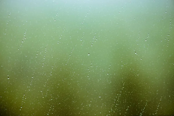 Brudne Szkło Kroplami Deszczu Krople Deszczu Zielonym Jasnym Tle Bokeh — Zdjęcie stockowe
