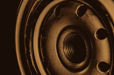Monochrome background image of oil filter close up. Art macro photography of auto part. Sepia tones.