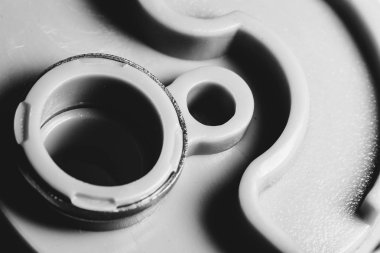 Monochrome background of plastic auto part close up. Macro photography in grayscale.