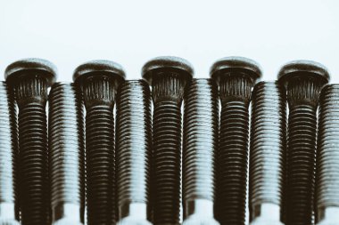 Monochrome artwork from automotive bolts close up.