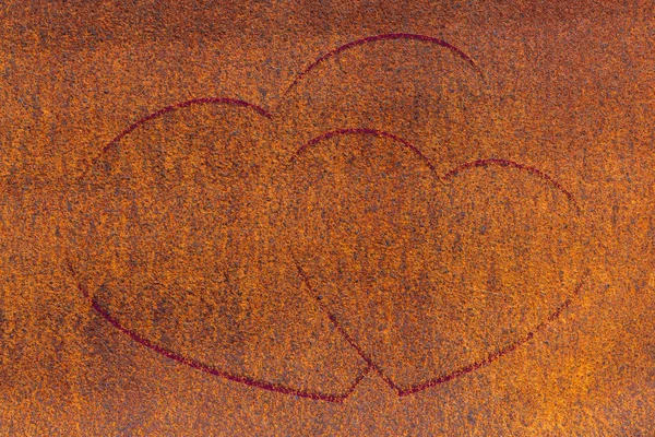 Two drawn hearts on oxide surface close-up. Rust metallic background with two painted hearts. Rust metall with love symbol graffiti. Valentine day image. Unideal iron plane with copy space.