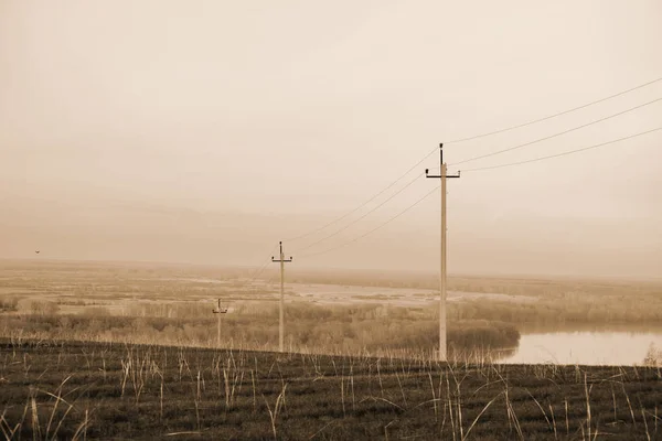 Atmosferyczne Krajobraz Linii Energetycznych Polu Tle Rzeki Pod Sepii Nieba — Zdjęcie stockowe