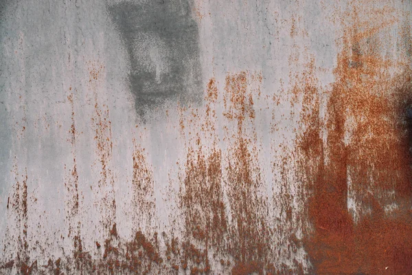 Rust on metallic surface. Iron texture. Partly rusty background. Rough oxide plate close-up. Hard decay of metal. Oxidation of steel. Chemical reaction. Partially rusted metal panel with peeling paint