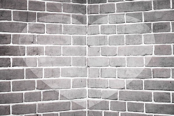 Symmetric drawn heart on angle of brick wall close-up in grayscale. Monochrome background with painted heart. Interior with love symbol decor. Valentine day image on wall. Brickwork. Exterior picture.