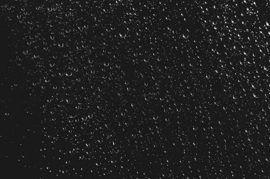 Yağmur damlalarıyla kirli pencere camı. Yağmur damlaları ile atmosferik tek renkli koyu arka plan. Damlacıklar ve lekeler kapanır. Kopyalama alanı ile makroda ayrıntılı saydam doku. Gece yağmurlu hava.