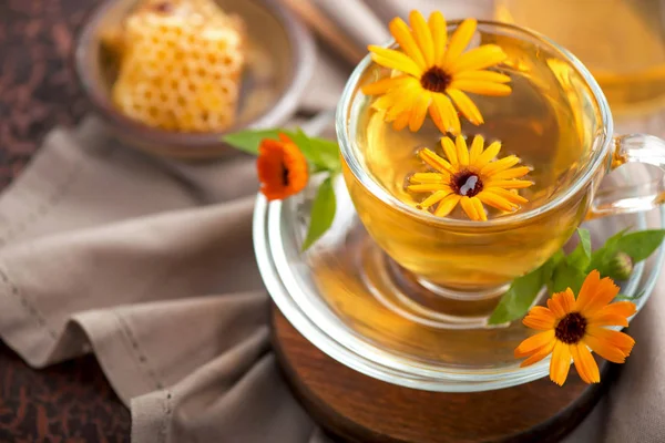 A cup of calendula marigold tea on a table — Stock Photo, Image