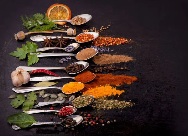Kryddor och kryddor för matlagning på svart bakgrund — Stockfoto