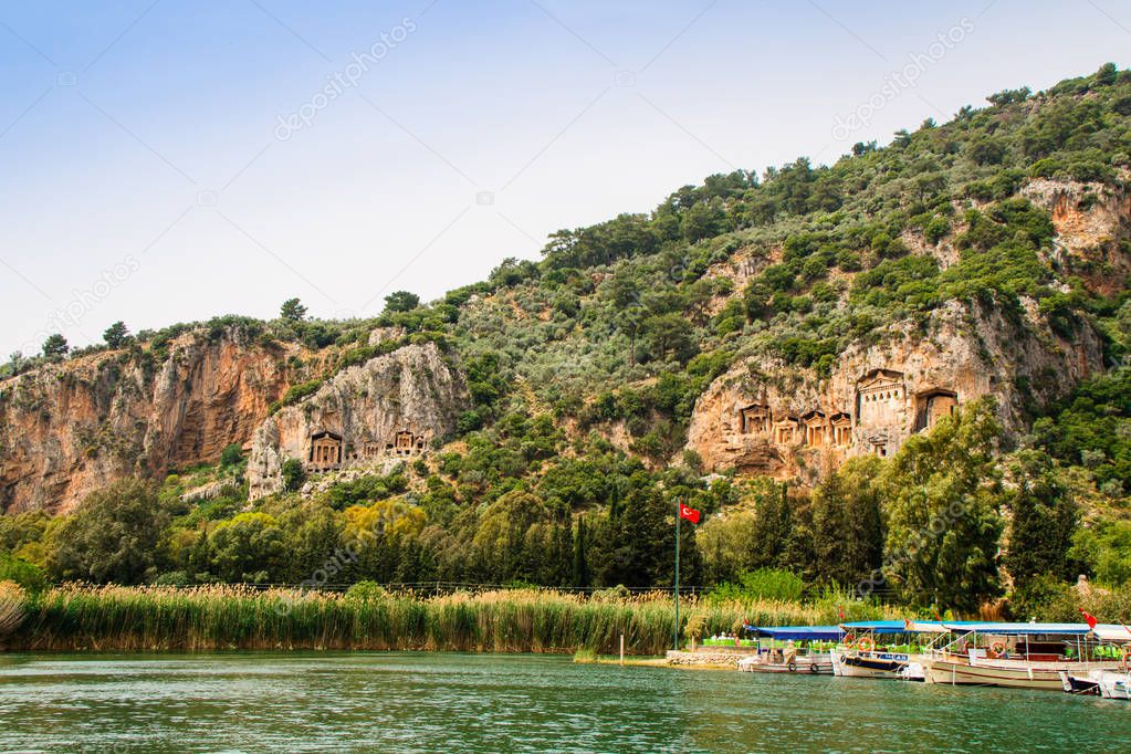 River Dalyan in Turkey with the sheer cliffs and the weathered facades of Lycian tombs cut from rock, circa 400 BC.