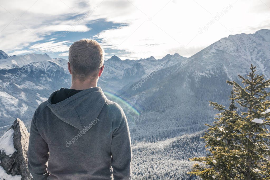 One guy with glasses and a jacket looks at the beautiful panoram