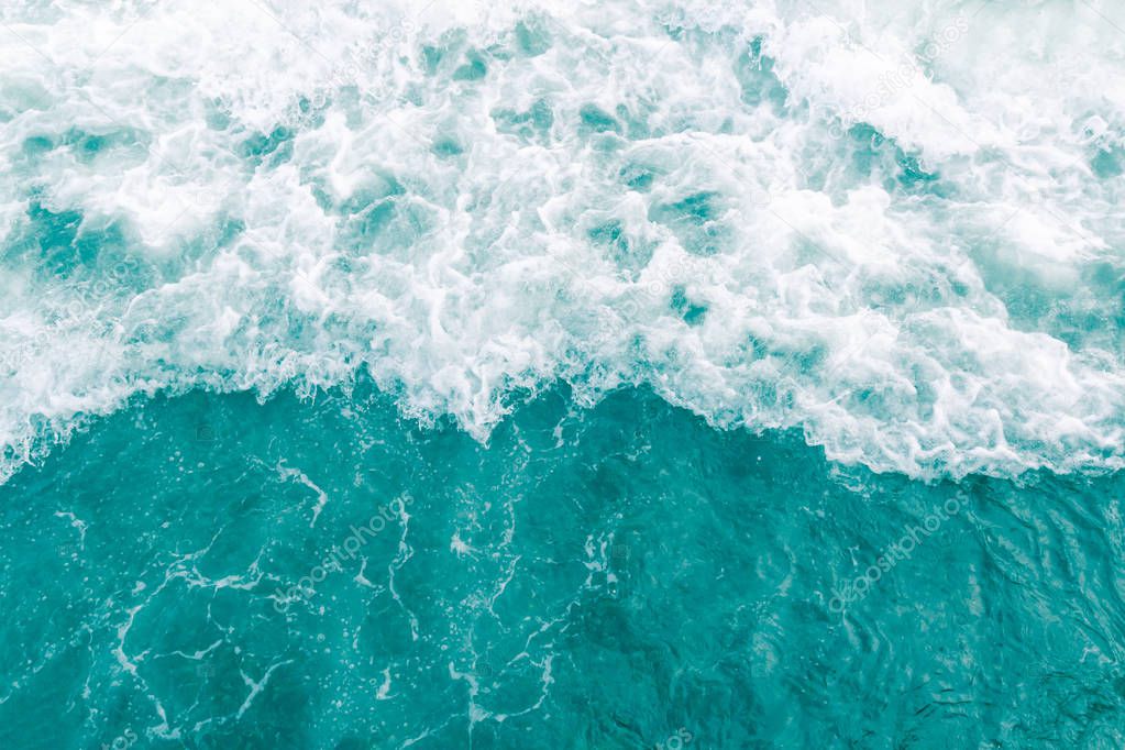 Turquoise olive green ocean wave during summer tide