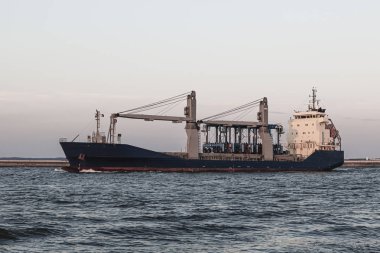Large industrial cargo ship sailing on the sea 